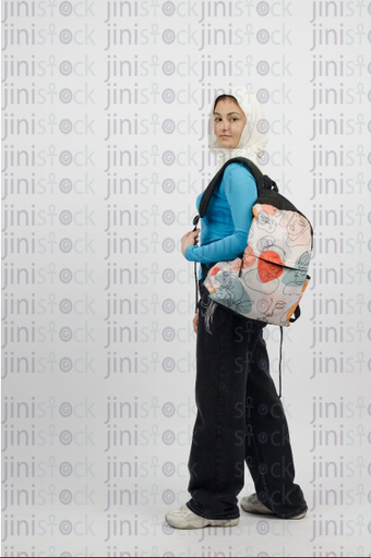 Hijabi girl carrying a backpack - smilling - close-up profile