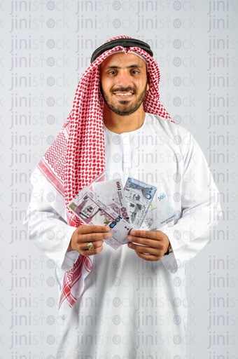 Saudi man holding Saudi Arabia riyals in his hands