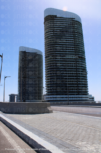 side walk on a high way with high glass building at the back in alameine