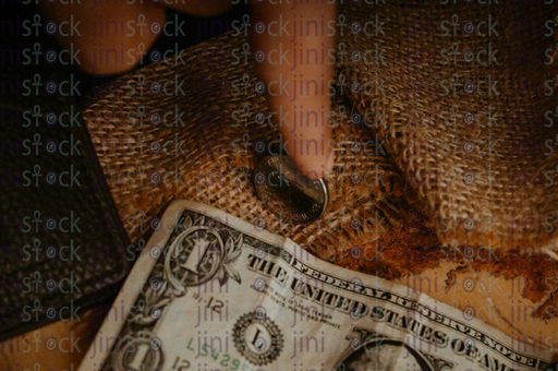 watch next to coins and money - stock image