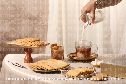 Tea with milk in the middle of Eid kahk and biscuits mix