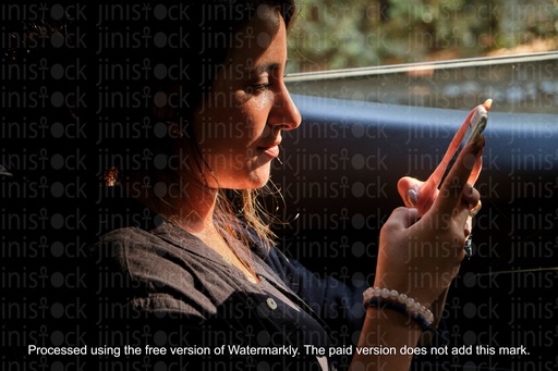 Girl texting in the car back seat