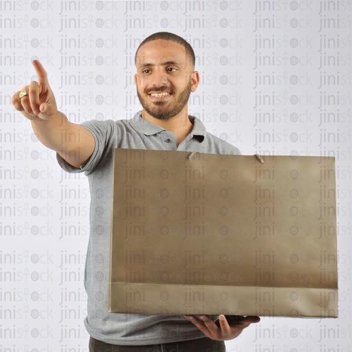 A man holding a shopping bag and pointing at something