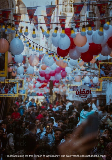 crowded street with balloons