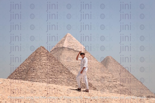 male model posing infront of the three pyraminds of giza