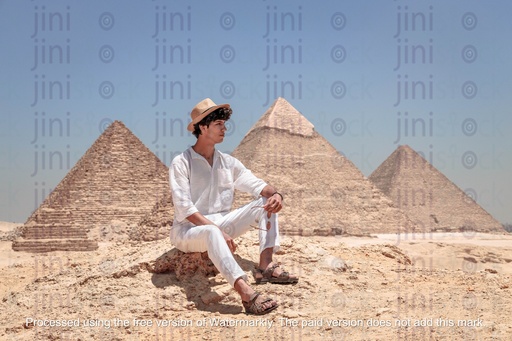 man sitting at the giza pyramids