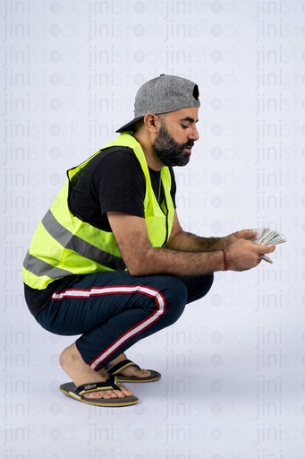 Egyptian car attendant or a sais counting money