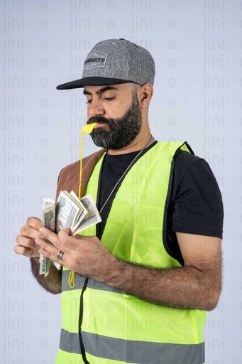 Sais or Egyptian car attendant  counting money and a whistles in his mouth