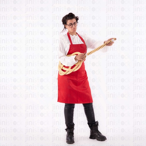 Egyptian housewife wearing a red apron using a cleaning stick as a guitar