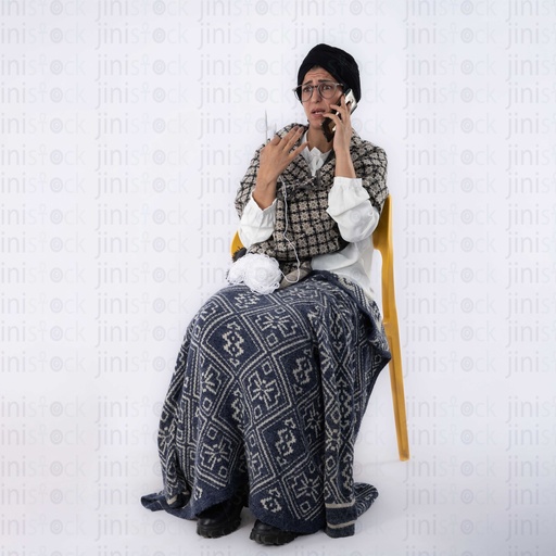 Old Egyptian grandmother talking on the phone worried