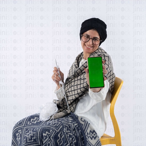 Egyptian old woman holding a mobile with green screen