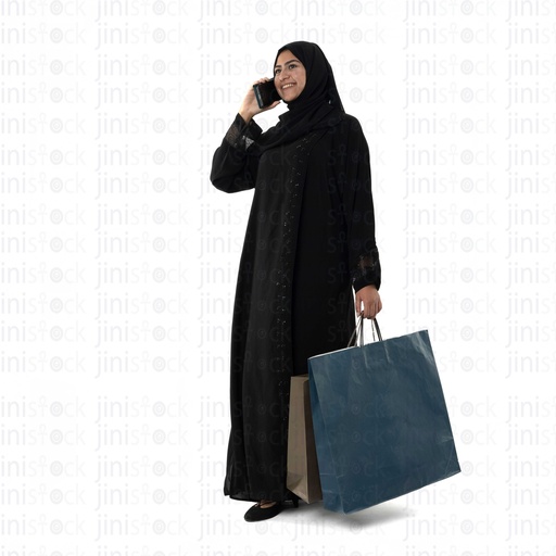 Khaliji woman talking on the phone while shopping