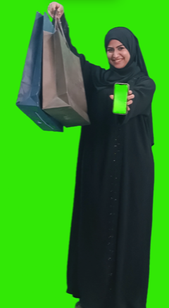 Khaliji woman holding a mobile with green screen and shopping bag