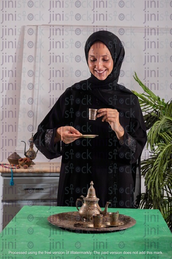 khaliji girl drinking arabian coffee