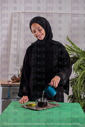 khaliji girl adding milk to the coffee