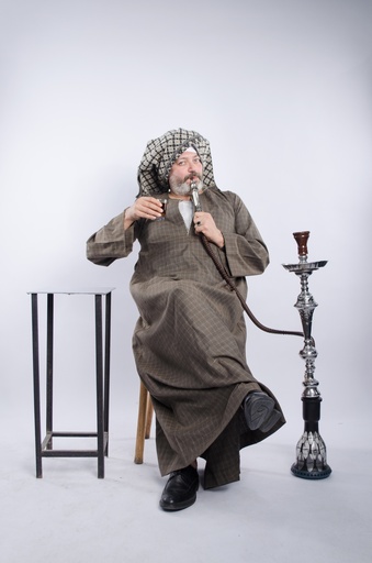 man in galabia drinking tea