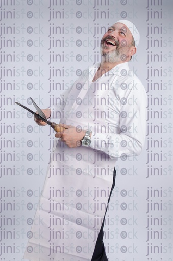 butcher laughing while holding knives