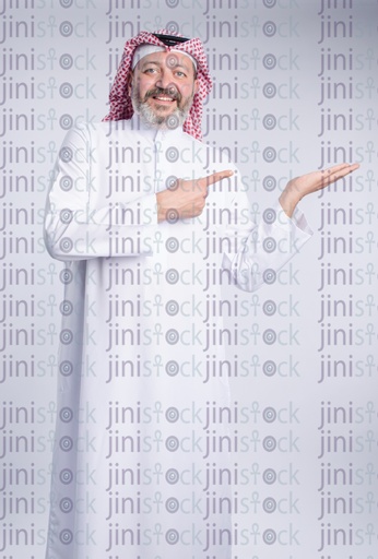 older khaliji man pointing at a product in his hands