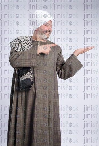 Older egyptian man from upper egypt pointing at somethign in his hands