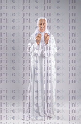 Old woman raising her hands for prayer