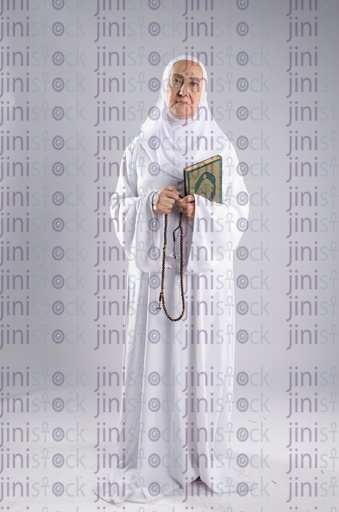 Old woman holding Qur'an and sabha