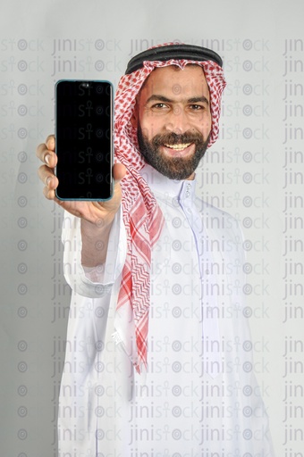 A man from the Gulf "Saudi or Emirati" holding a mobile phone to recommend a mobile application