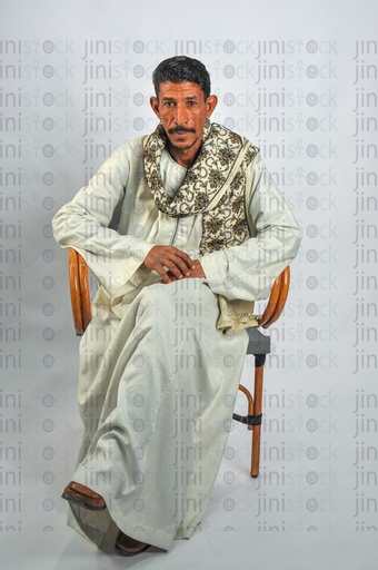 An upper Egypt man sitting on a chair