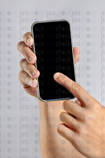 close up shot of a hand of a man holding a mobile phone and pointing at it for recommending a mobile app