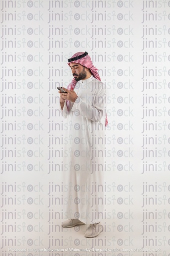 khaliji man looking at his phone