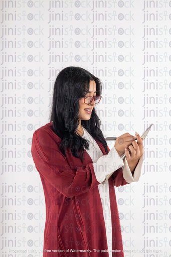 Khaliji Saudi woman holding a notepad and writing something