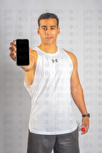 A young athlete holding a mobile phone in his hand and recommending using a mobile application