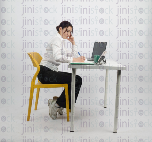 Woman writing and thinking - close-up - stock image