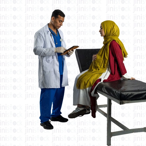 Pregnant Arabian woman wearing hijab on examination bed talking to the doctor