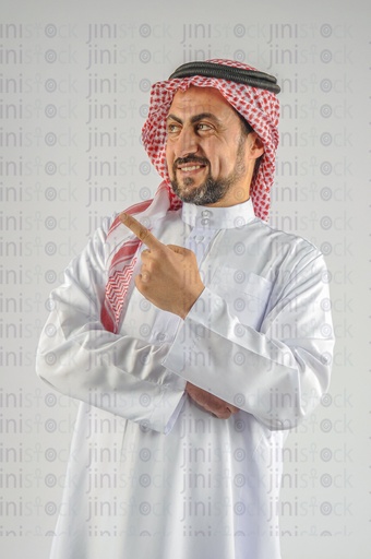 Khaliji, Saudi, Emirati, or Gulf man pointing at something.