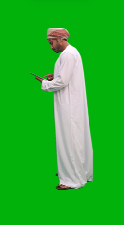 Omani khaliji gulf working on tablet then looking at the camera happy