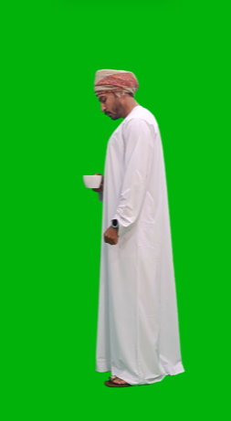 omani khaliji man  from gulf drinking tea or coffee side view