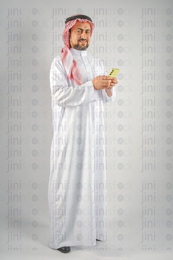 Khaleeji man Saudi, Emirati, or a Gulf man browsing a mobile application or texting on an mobile app