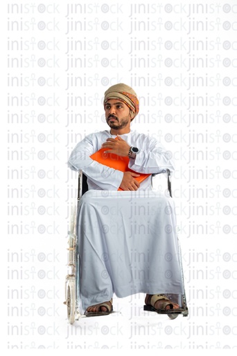 Omani khaliji man from gulf on a wheel chair holding a folder