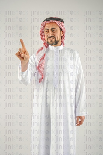 A man from the Gulf of Saudi Arabia or Emirates touching a screen in front of him