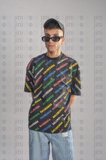 a cool young man wearing a cap, t-shirt, and jeans, and sunglasses.