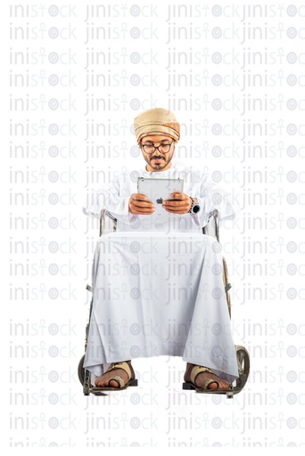 omani khaliji arab man from gulf on wheelchair checking  his ipad