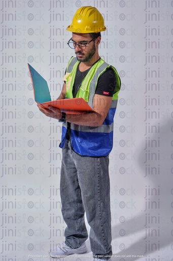 Egyptian engineer standing checking designs