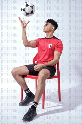 egyptian young man wearing the national Egyptian team Shirt football and spinning a ball
