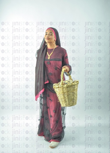 A Nubian Egyptian girl wearing Nubian clothes holding a basket in her hand for putting vegetables or fruits