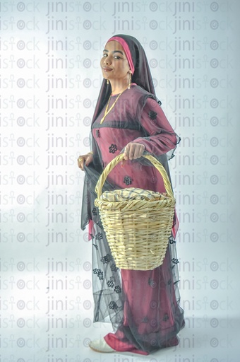 A Nubian Egyptian girl wearing Nubian clothes holding a basket in her hand for putting vegetables or fruits