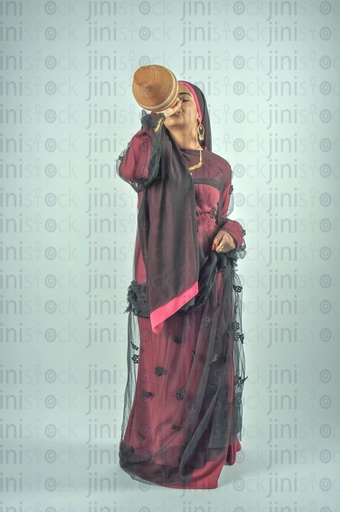 Nubian Egyptian woman wearing Nubian clothes or farmer drinking water from Qola