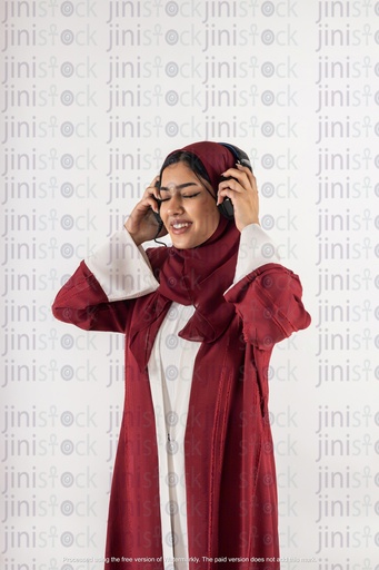 khaliji woman listening to music in headphones stock image