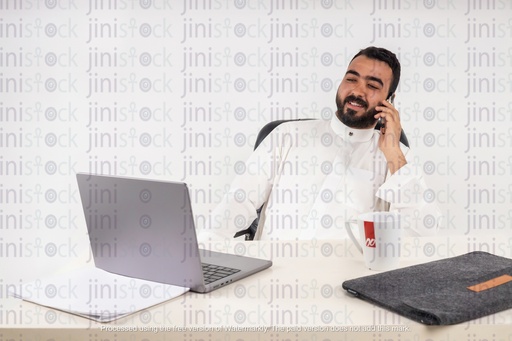 a stock image of a gulf business man working and talking on mobile