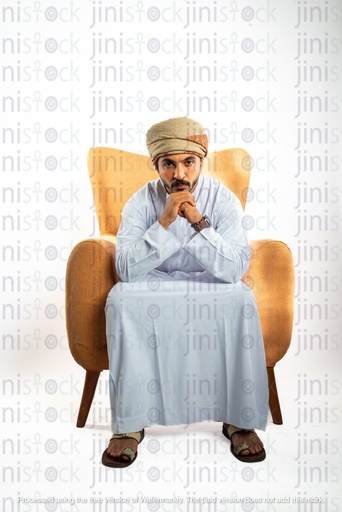 omani from oman khaliji man from gulf sitting on a chair looking to the camera