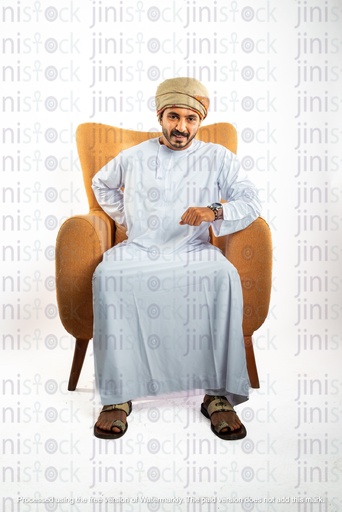 omani from oman khaliji man from gulf sitting on a chair with lower back pain